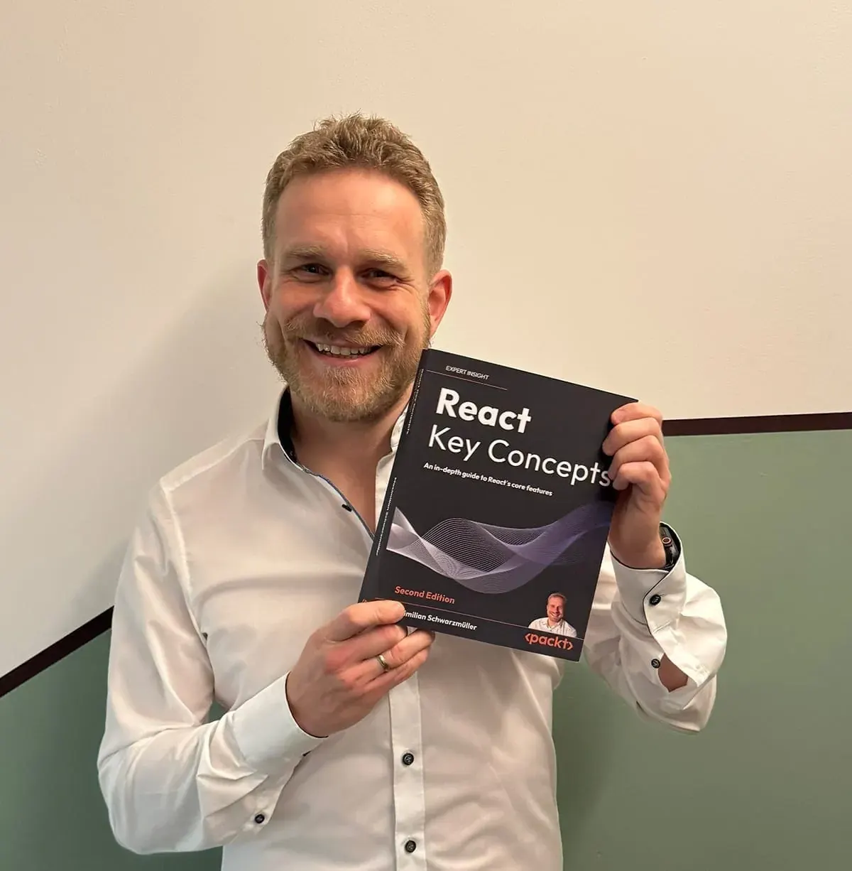 Max holding a physical copy of his book React Key Concepts